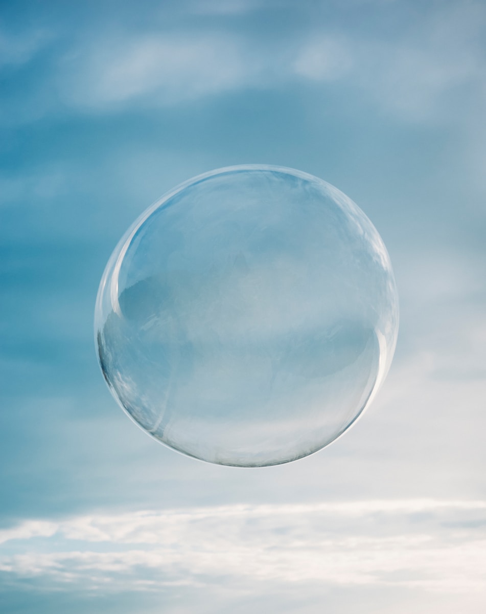 a clear bubble floating in the air on a cloudy day